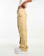 The Couture Club cargo pants in black with multiple pockets and buckle  detail