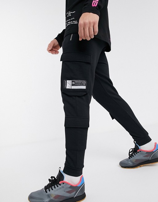 The Couture Club jersey cargo trousers with zips in black