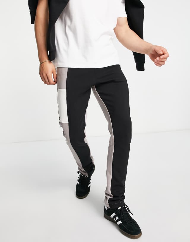 The Couture Club jersey sweatpants in gray and black splicing - part of a set