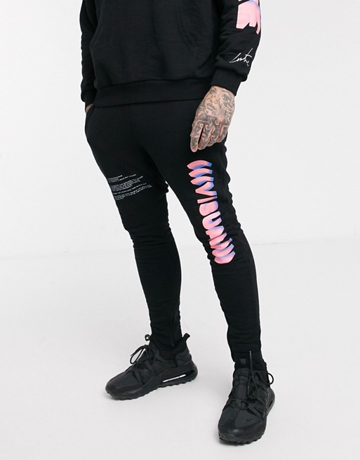 The Couture Club joggers in black with graphic print