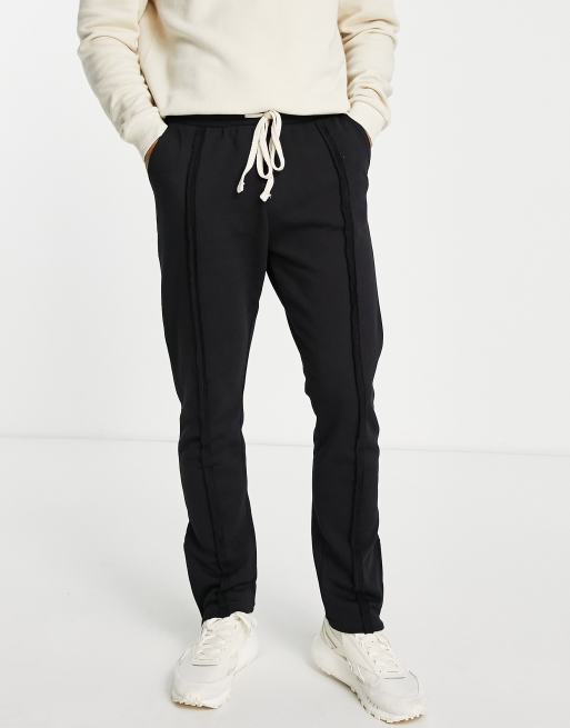 The Couture Club – Jogginghose in Schwarz im Used-Look mit geschlitztem Saum und Ziernaht