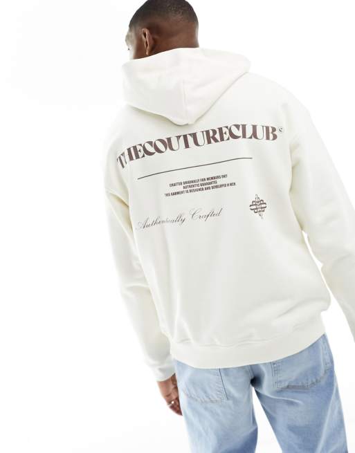 The Couture Club – Kapuzenpullover in gebrochenem Weiß mit Grafikprint auf dem Rücken 