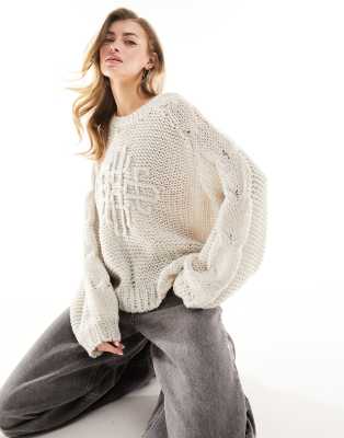 The Couture Club open stitch emblem jumper in cream