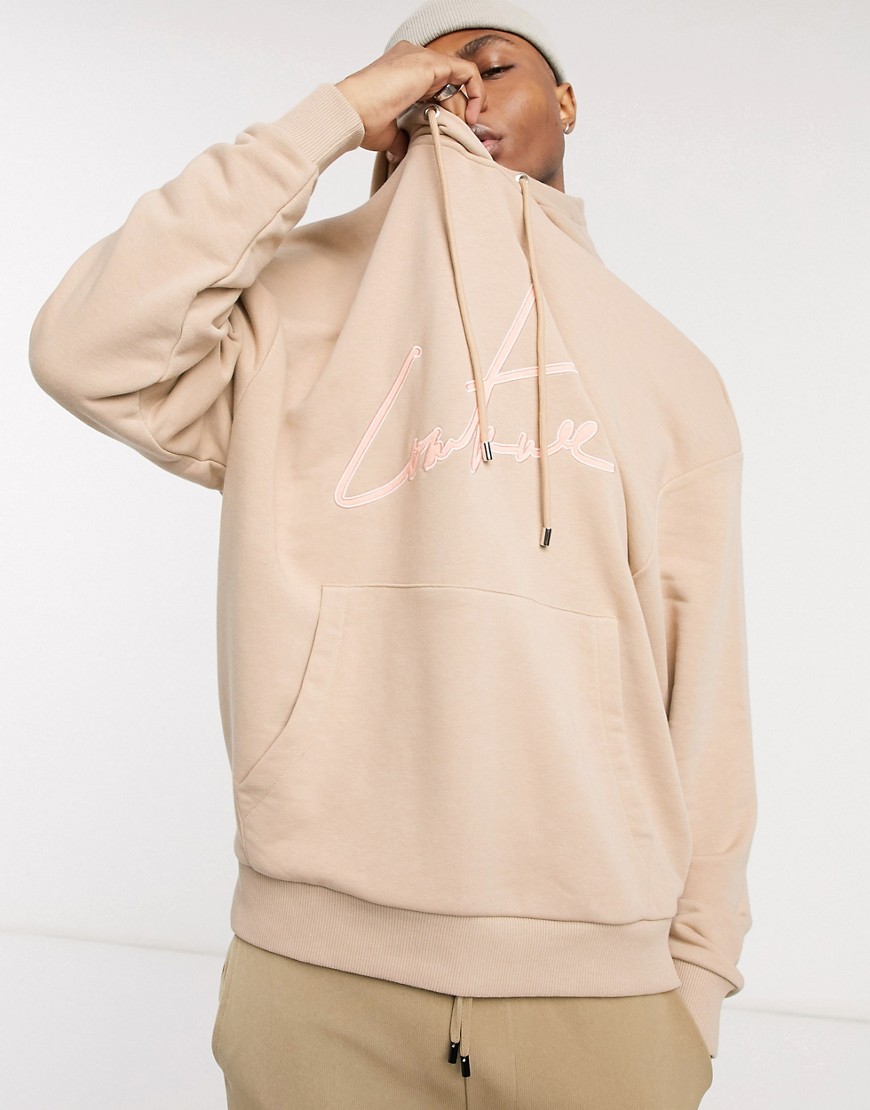 The Couture Club oversized applique signature hoodie front and hood logo in beige