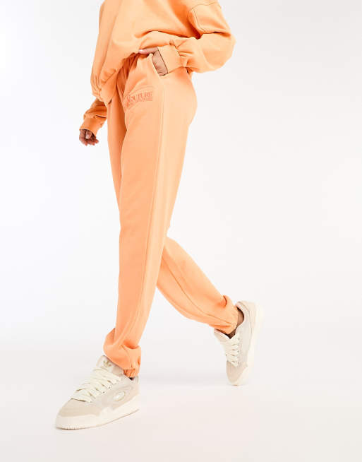 The Couture Club oversized sweatpants in orange part of a set