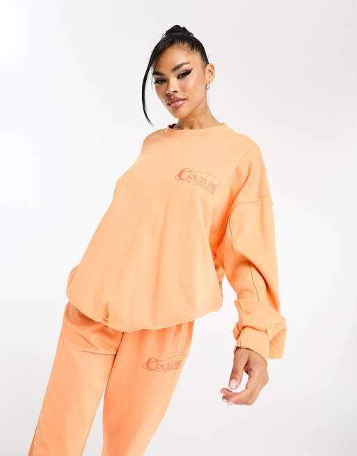 The Couture Club – Pomarańczowa bluza oversize z nadrukiem na plecach, część zestawu