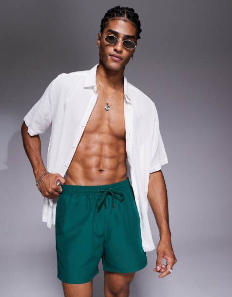 The Couture Club reactive emblem swim shorts in green - view 1