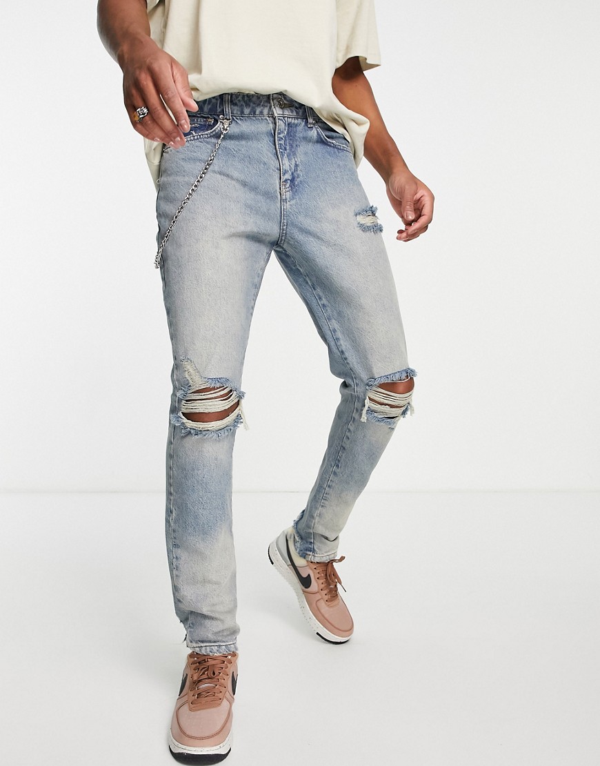 The Couture Club Relaxed Fit Denim Jeans In Midwash Blue With Knee Rips And Chain Detail