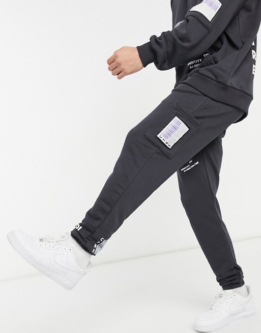 The Couture Club relaxed printed joggers in charcoal