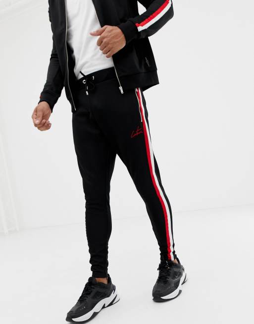 The Couture Club tracksuit in black with red stripe stripe