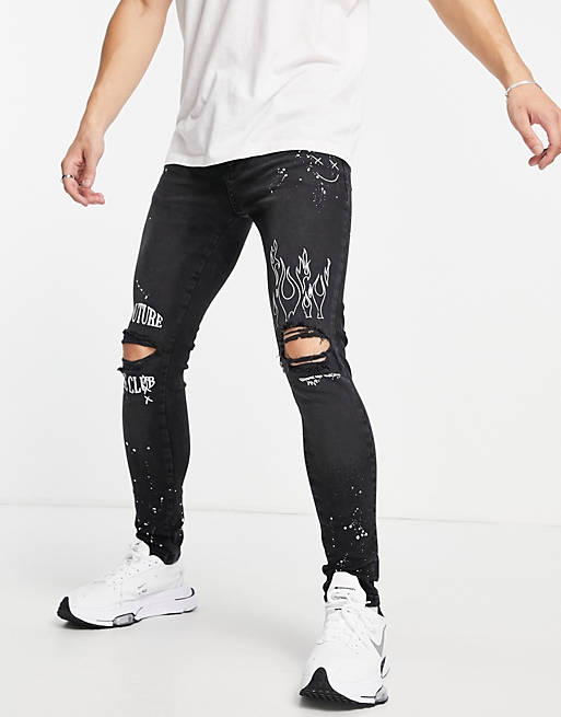 The Couture Club slim jeans in black with knee rips and embroidery