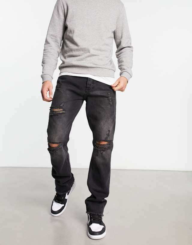 The Couture Club straight leg denim jeans in black with ripped knee detail