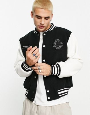 The Couture Club varsity jacket in black and white with emblem script embroidery