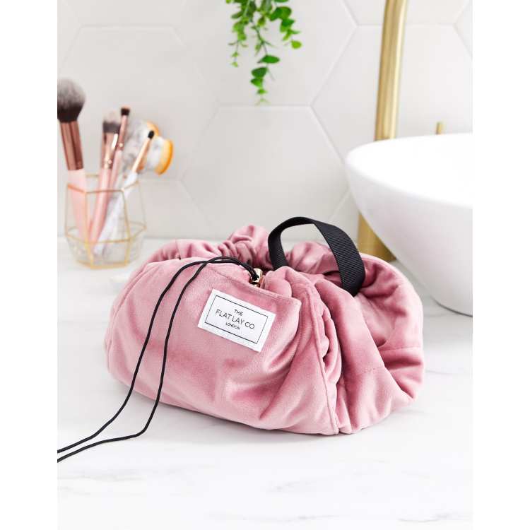 Spa composition with bath accessories in a pink string bag, flat lay. Stock  Photo by puhimec