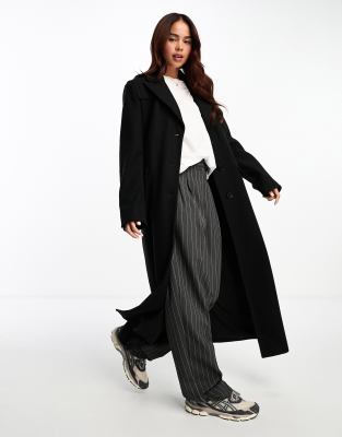 The Frolic - Cappotto nero taglio lungo con spalle voluminose