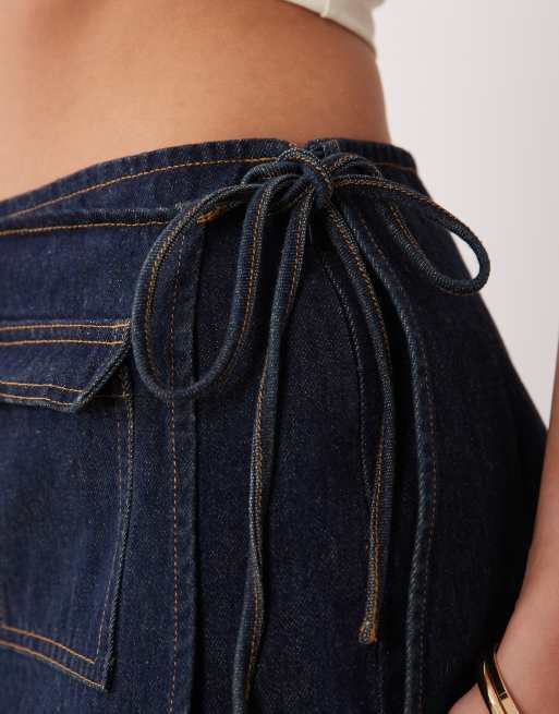 The Frolic exclusive denim pocket front tie side mini skort in dark blue, 4 of 5