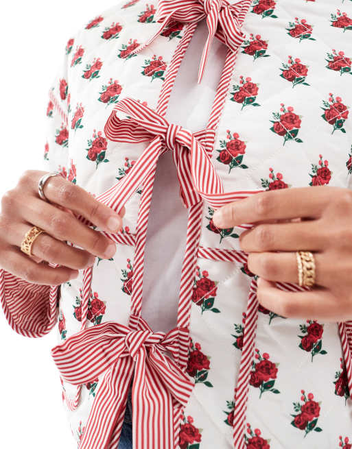 The Frolic exclusive quilted bow tie front reversible jacket in cream floral and red stripe  