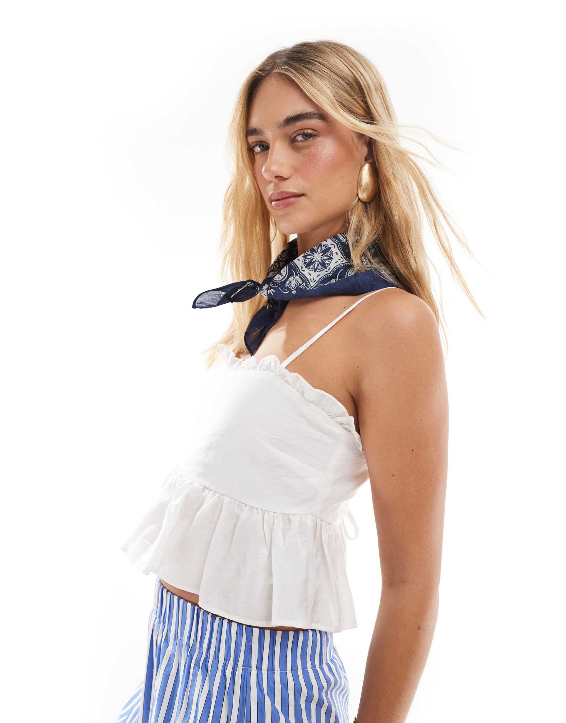 the frolic exclusive ruffle trim tie back babydoll cami top in white