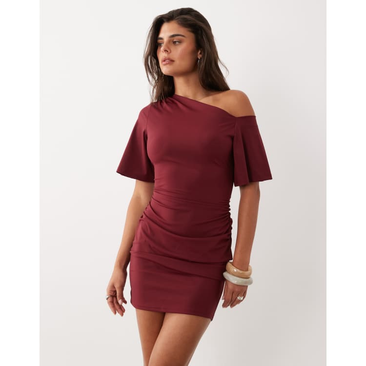 The Frolic exclusive slinky asymmetric off shoulder ruched side mini dress in burgundy