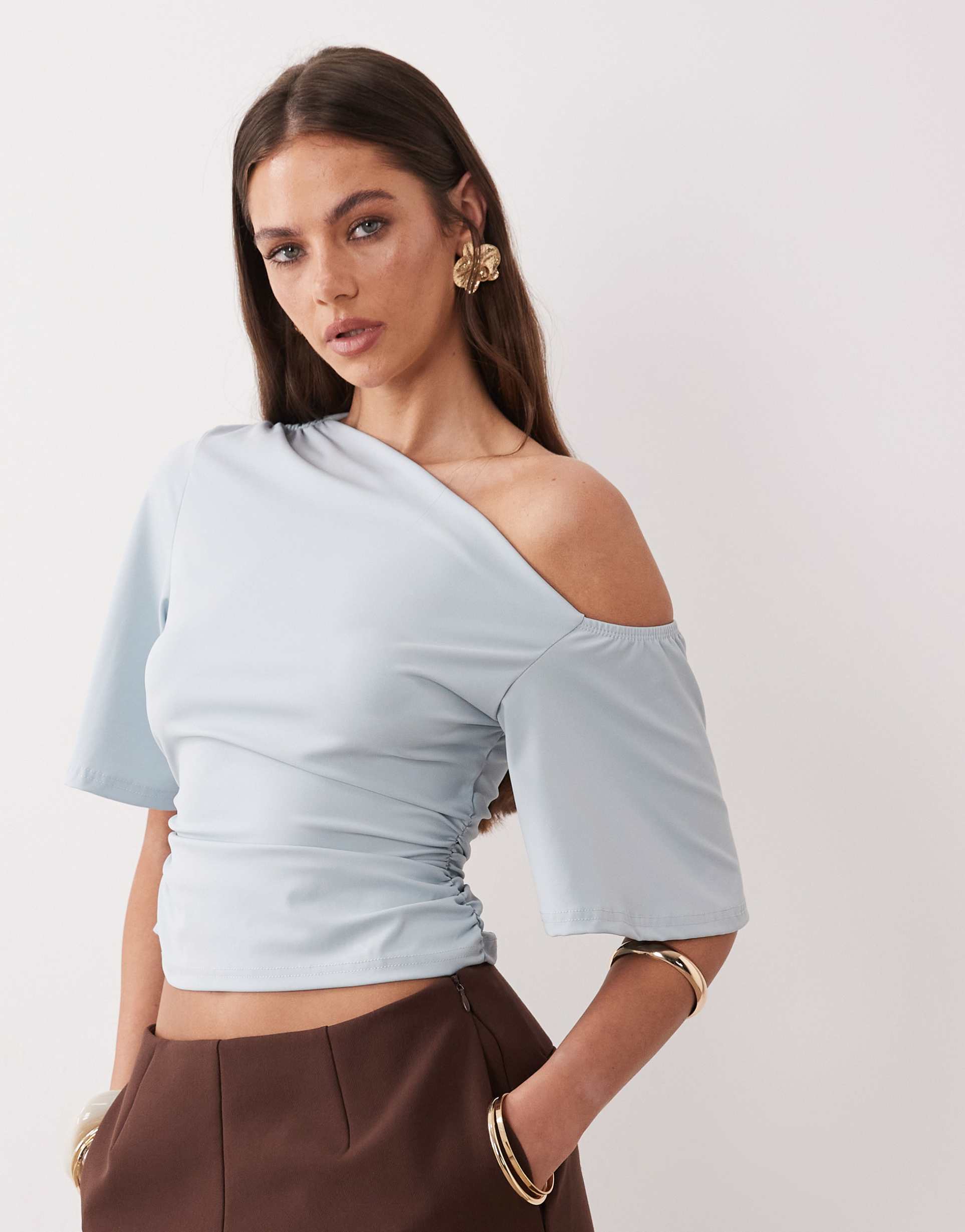 the frolic exclusive slinky asymmetric off shoulder ruched side top in baby blue
