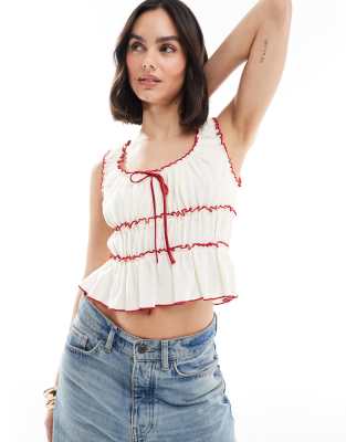 The Frolic - Exclusives - Peplumtop met contrasterende bies en strikdetail in crème en rood  