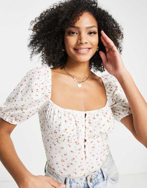 The Frolic - Piqué body met fijne bloemenprint in wit