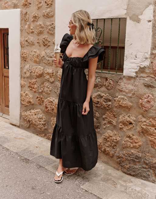 The Frolic X Lyds Butler escora frill detail tie back maxi tiered beach dress in black ASOS