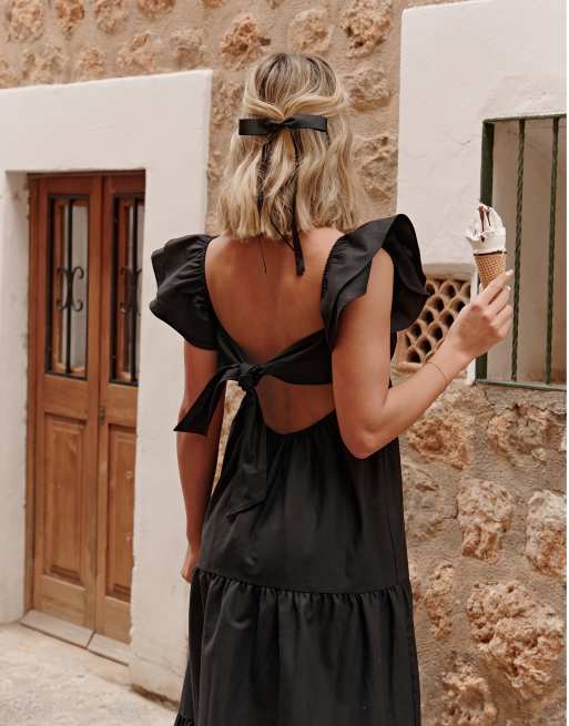 The Frolic X Lyds Butler escora frill detail tie back maxi tiered beach dress in black ASOS