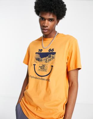 The North Face 1966 Smiley Face t-shirt in orange Exclusive at ASOS