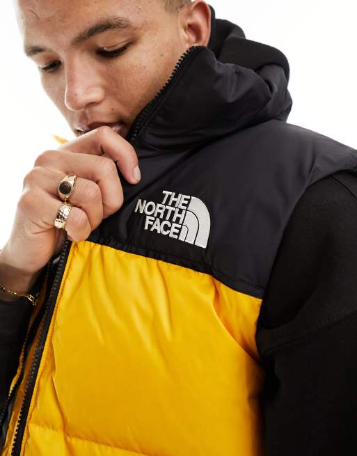 The North Face 1996 Nuptse down puffer vest in black and yellow