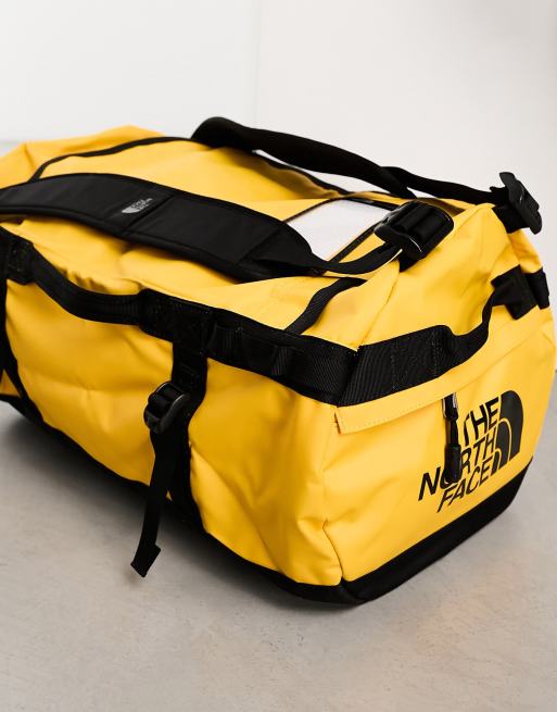 The North Face Base Camp small 50l duffel bag in yellow and black ASOS