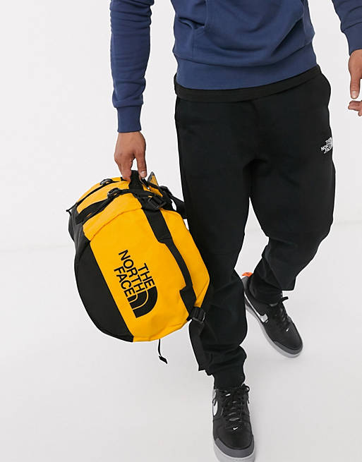 Van stok doe niet The North Face Base Camp small duffel bag 50L in yellow | ASOS