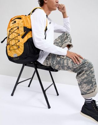 black and yellow north face backpack