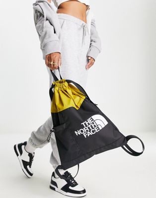 The North Face Bozer cinch bag in yellow and black
