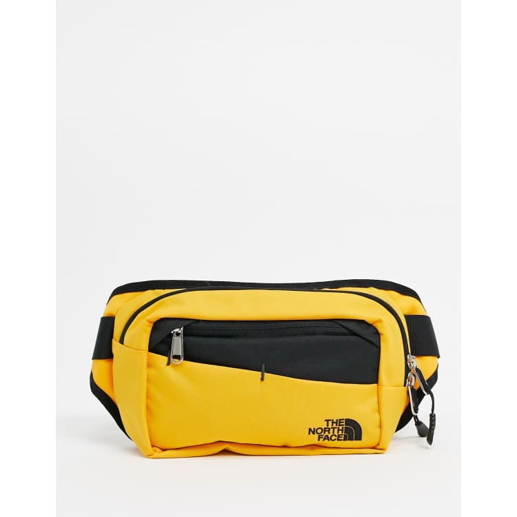 The North Face Bozer II fanny pack in yellow ASOS