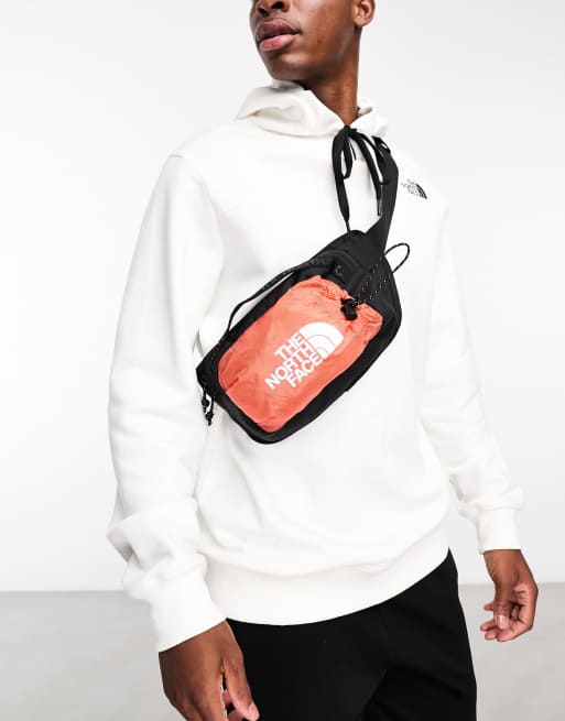 The North Face Bozer III bum bag in orange and black