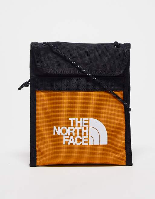 The North Face Bozer neck pouch in orange and black ASOS