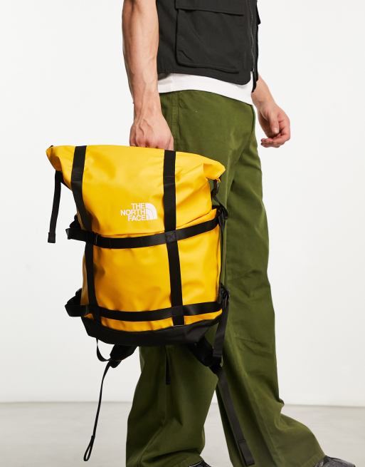 The North Face Commuter roll top backpack in yellow and black