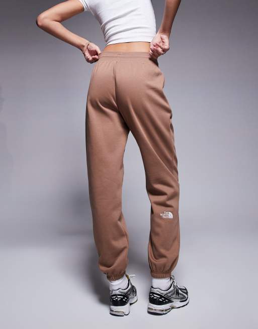 The North Face Essential logo relaxed cuff trackies in brown ASOS