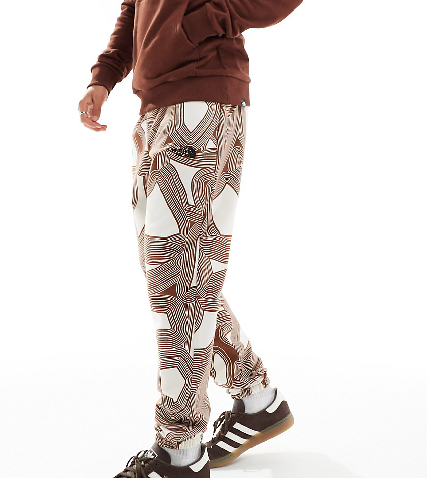 The North Face Essential oversized fleece joggers in brown geo print Exclusive at ASOS