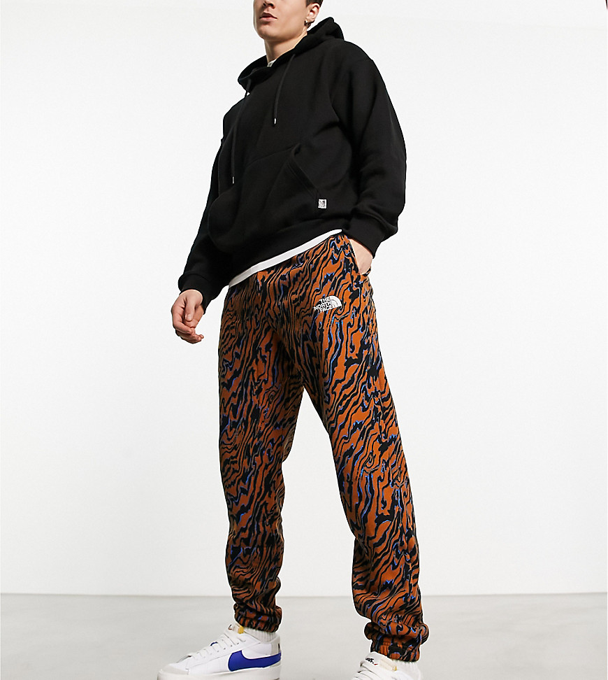 The North Face Essential oversized joggers in brown marble print Exclusive at ASOS