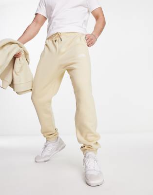 The North Face Essential oversized joggers in stone Exclusive at ASOS-Neutral