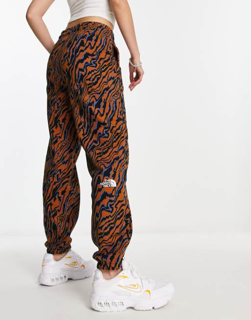 The North Face Essential oversized trackies in brown marble print Exclusive at ASOS