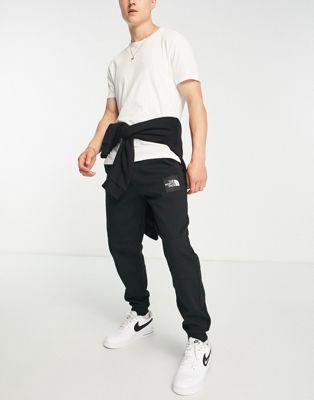 The North Face Fine logo trackies in black - ASOS Price Checker