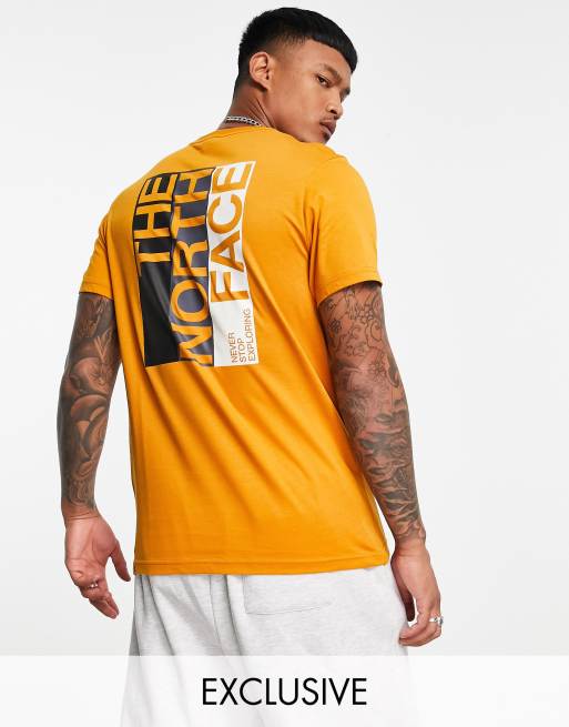 Orange north face store shirt