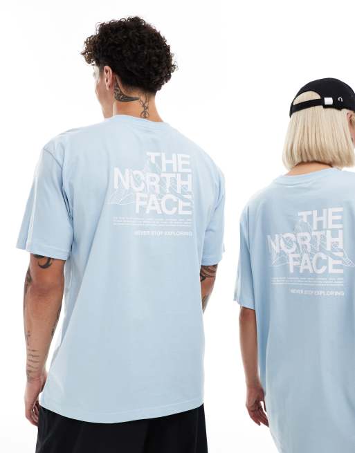 The North Face – Jasnoniebieski T-shirt oversize z nadrukiem rysunku gór na plecach