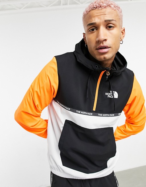 The North Face Mountain Athletic wind jacket in black/orange