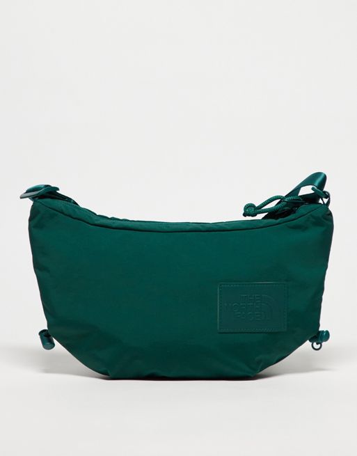 Calvin Klein Jeans tote bag exemplifies understated glamour through its timeless shape Never Stop logo crossbody bag in green
