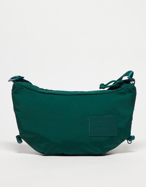 Calvin Klein Jeans tote bag exemplifies understated glamour through its timeless shape Never Stop logo crossbody bag in green