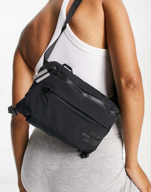 The North Face Never Stop Lumbar cross body bag in black | ASOS